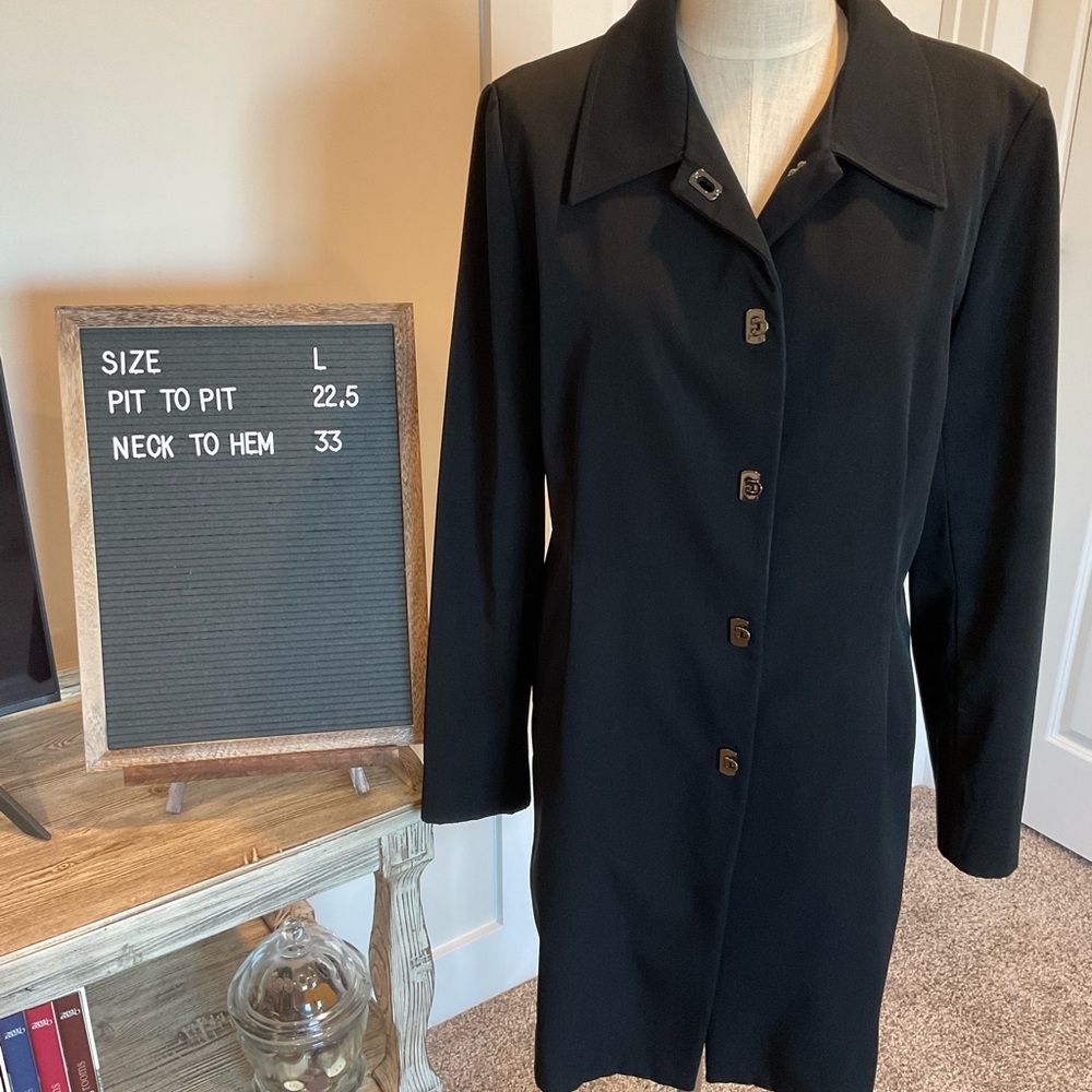 Vintage black trench coat with unique latch closures.